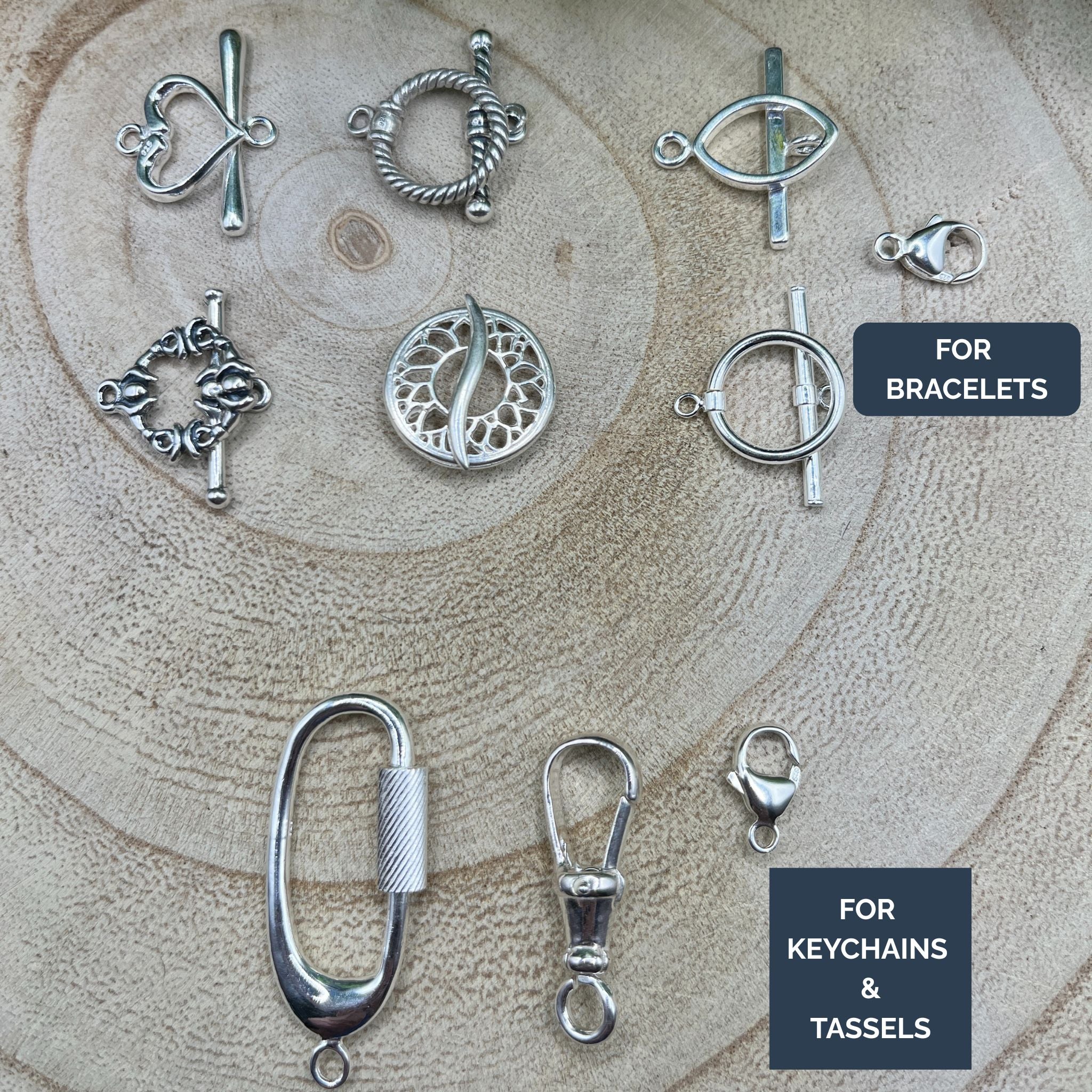 Collection of silver jewelry components on a wooden surface with labels for bracelet, keychain, and tassel uses.